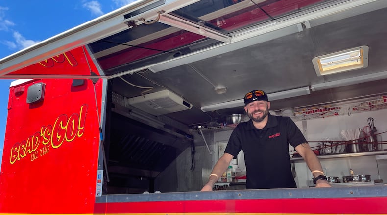 If you’re looking for a late-night food option in Dayton’s Oregon District, Brad’s on the Go! is offering a rotating menu of tacos, nachos, tater barrels, walking tacos and more outside of NextDoor. Pictured is Owner Brad Hamilton. NATALIE JONES/STAFF