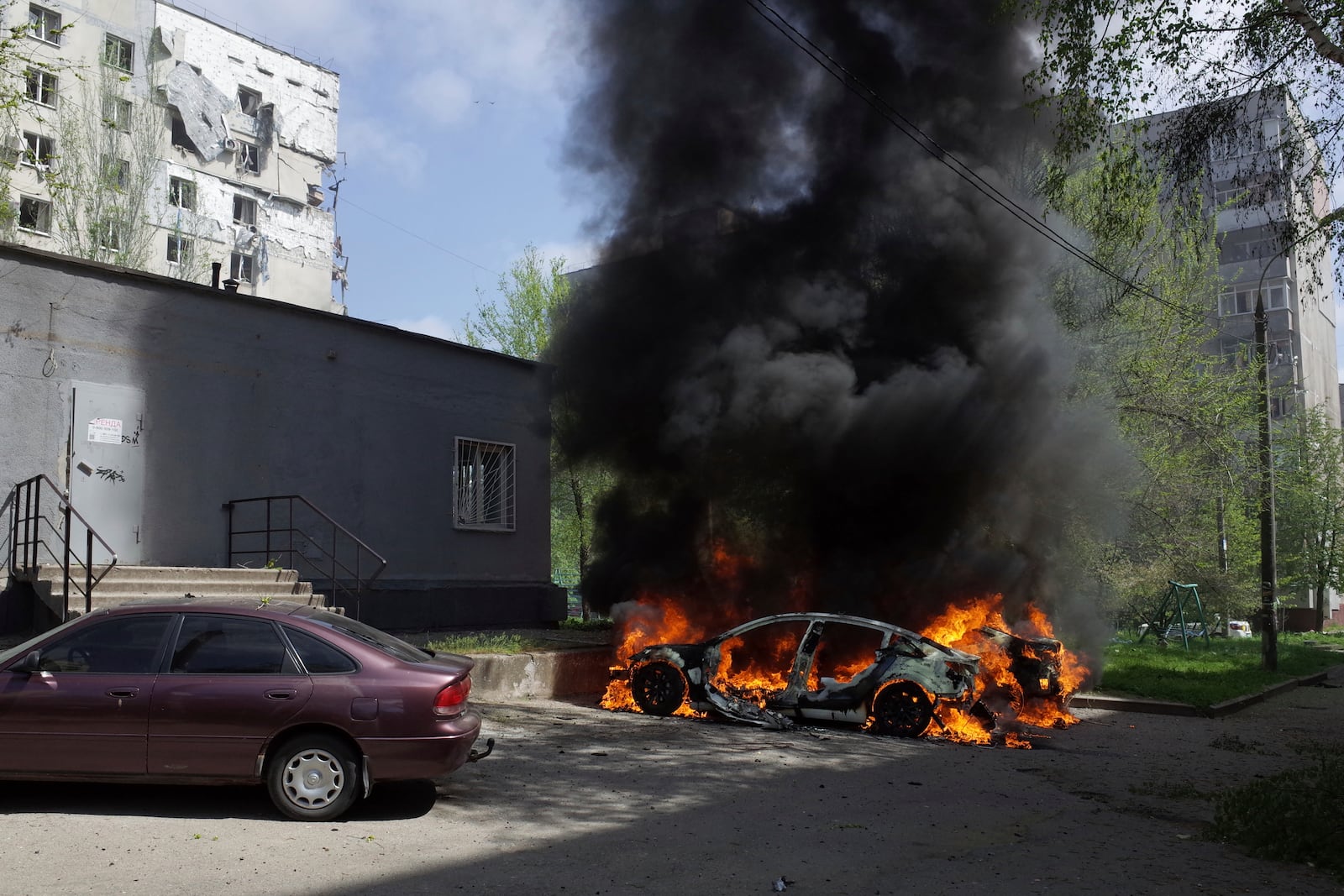 A car burns near a residential building damaged by a Russian strike in Zaporizhzhia, Ukraine, Tuesday, April 22, 2025. (AP Photo/Andriy Andriyenko)