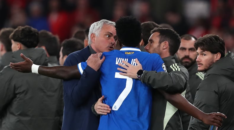 Real Madrid's Vinicius Junior argues with Benfica's head coach José Mourinho after scoring the opening goal during a Champions League playoff soccer match between SL Benfica and Real Madrid in Lisbon, Portugal, Tuesday, Feb. 17, 2026. (AP Photo/Pedro Rocha)