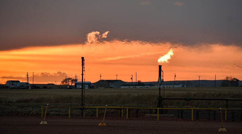 Flares burn natural gas from oil production in the Fort Berthold Indian Reservation east of New Town, North Dakota, May 18, 2021. (AP Photo/Matthew Brown, File)
