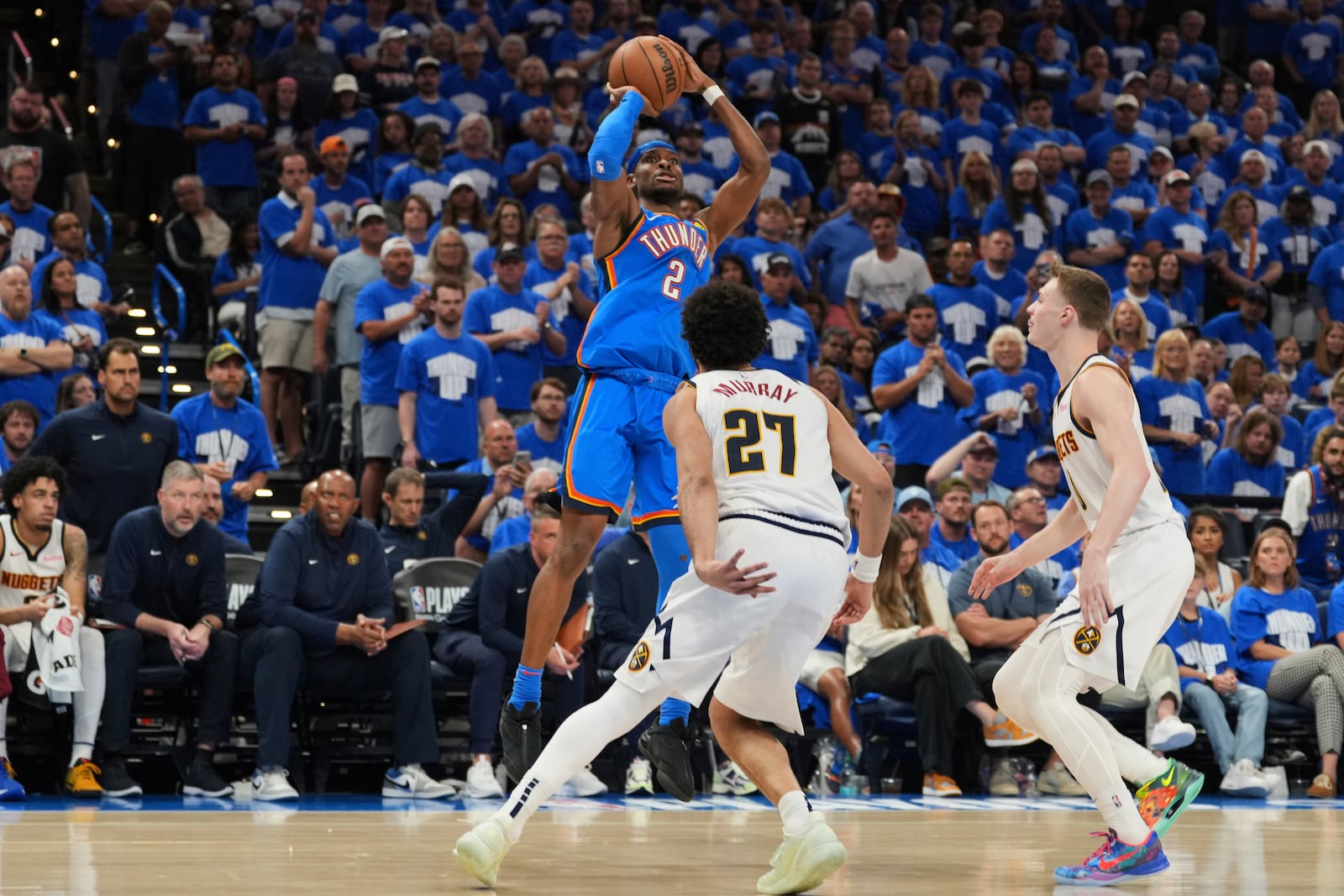 Oklahoma City Thunder guard Shai Gilgeous-Alexander (2) shoots over Denver Nuggets' Jamal Murray (27) and Christian Braun, right, in the second half of Game 7 in the Western Conference semifinals of the NBA basketball playoffs, Sunday, May 18, 2025, in Oklahoma City. (AP Photo/Kyle Phillips)