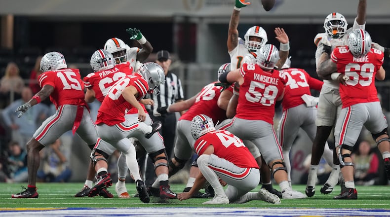 Ohio State kicker Jayden Fielding, with Joe McGuire holding, misses a field goal against Miami during the first half of the Cotton Bowl College Football Playoff quarterfinal game Wednesday, Dec. 31, 2025, in Arlington, Texas. (AP Photo/Julio Cortez)