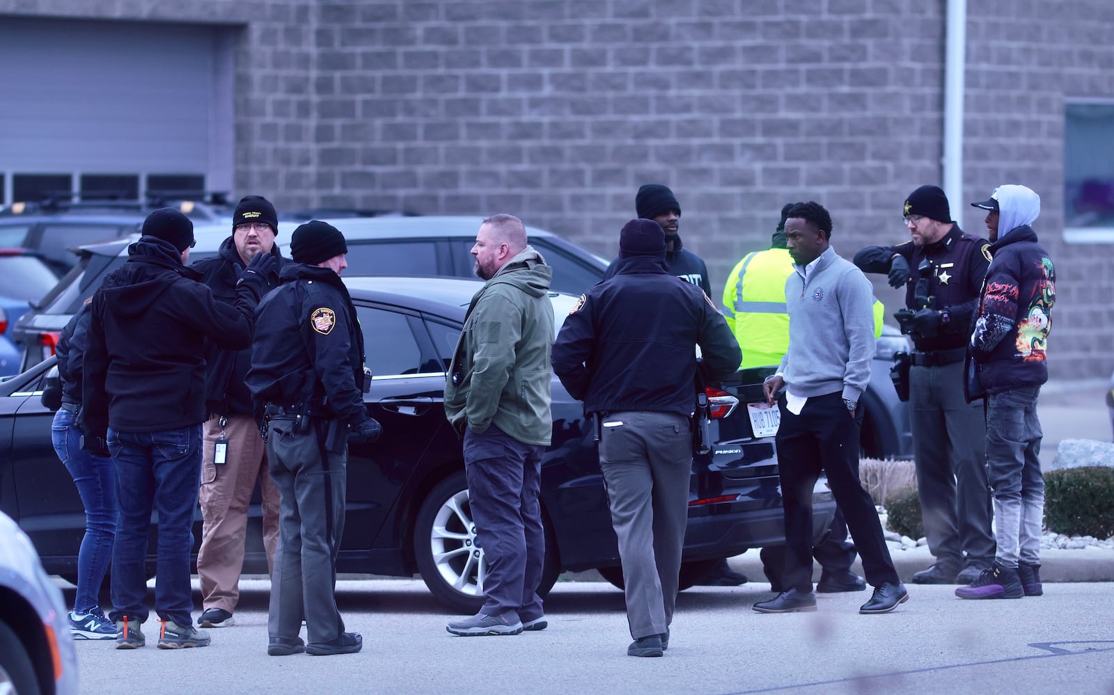 Law enforcement officers meet in the parking lot across from the Sportsplex center on Sunday, Nov. 30, 2025 on Dayton Road in Fairborn. MARSHALL GORBY / CONTRIBUTED PHOTO