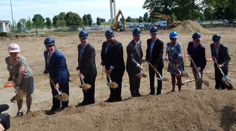 Brady Kress, center, president and chief executive, helped break ground Thursday with guests and friends for a new building at Carillon Park. CONTRIBUTED