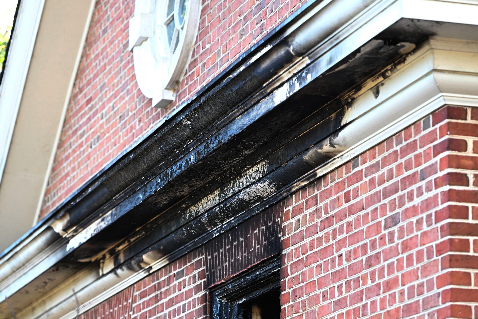 Charred wood trim and brick are visible at the Pennsylvania governor's official residence after a man was arrested in the alleged arson that forced Gov. Shapiro, his family and guests to flee in the middle of the night on the Jewish holiday of Passover, Sunday, Apr. 13, 2025, in Harrisburg, Pa. (AP Photo/Marc Levy)