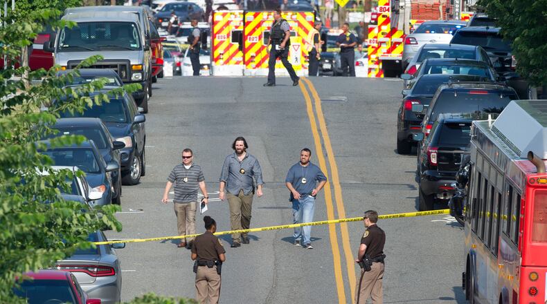 Police and emergency personnel are seen near the scene where House Majority Whip Steve Scalise of La. was shot during a Congressional baseball practice in Alexandria, Va., Wednesday, June 14, 2017. (AP Photo/Cliff Owen)