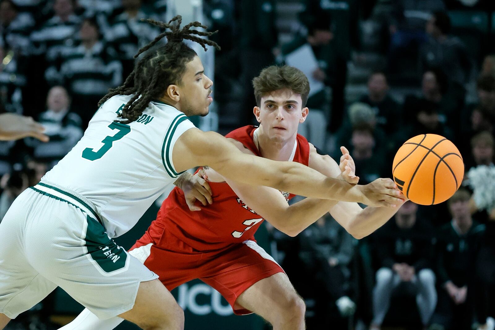 Eastern Michigan guard Mehki Ellison, left, fouls Miami (OH) guard Luke Skaljac, right, during the first half of an NCAA college basketball game, Tuesday, Feb. 24, 2026, in Ypsilanti, Mich. (AP Photo/Duane Burleson)
