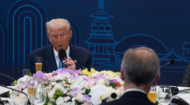 President Donald Trump looks towards Canada Prime Minister Mark Carney as he delivers remarks at a dinner hosted by South Korea President Lee Jae-Myung in Gyeongju, South Korea, Wednesday, Oct 29, 2025. (Adrian Wyld/The Canadian Press via AP)