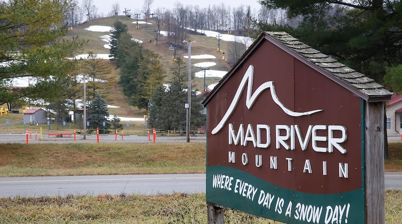 The sign outside Logan County's Mad River Mountain reads "Where Every Day is a Snow Day!" Tuesday, Dec. 26, 2023. With temperatures in the mid 50s Tuesday, there was no "Snow Day" at the ski resort. BILL LACKEY/STAFF
