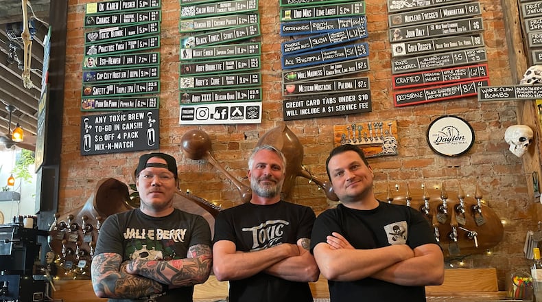 Toxic Brew Company, the first craft brewery in downtown Dayton, is celebrating its 10th anniversary. Pictured left to right is Tyler Glicher, Shane Juhl and Adam Stephens. NATALIE JONES/STAFF