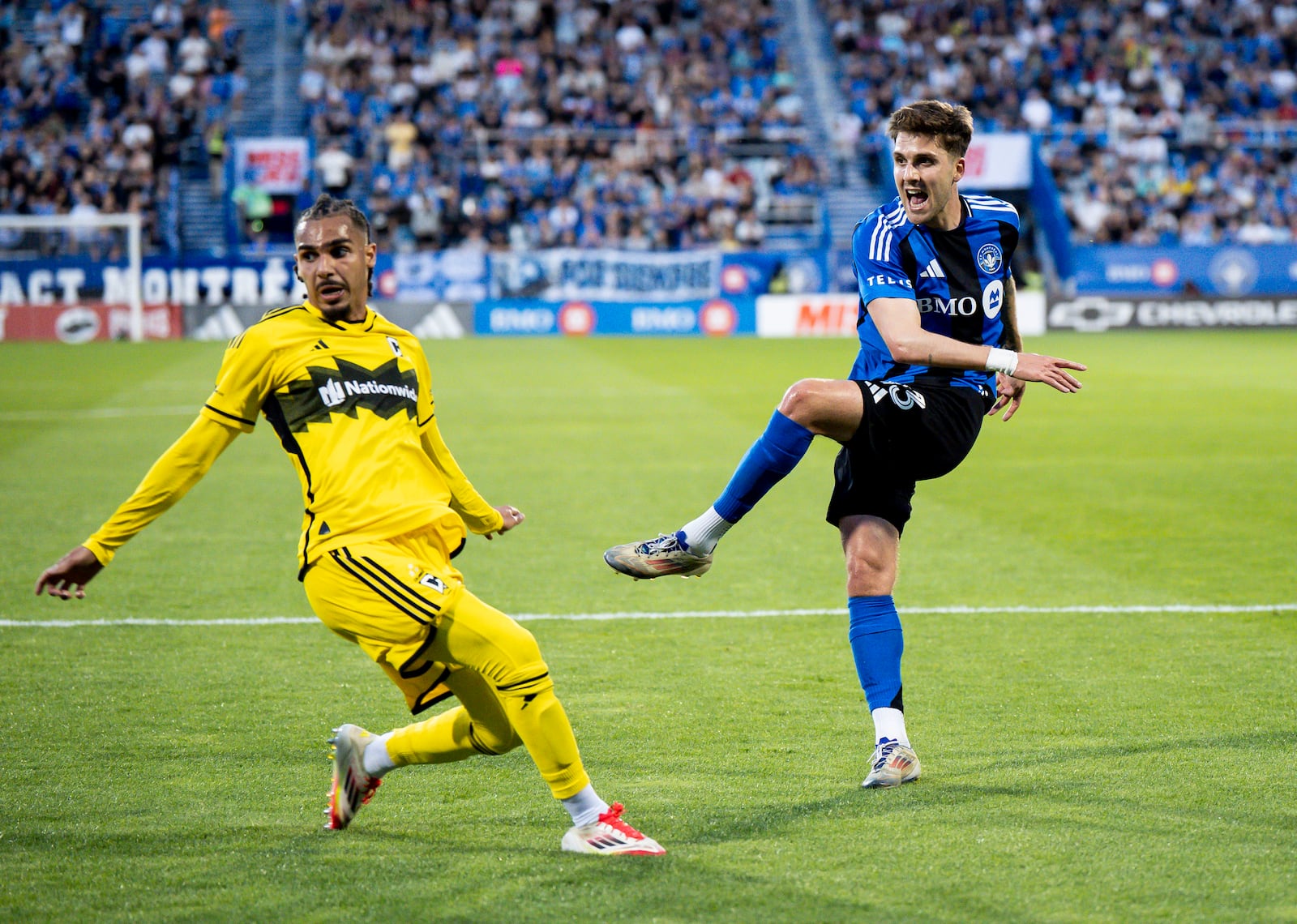 CF Montreal's Luca Petrasso (13) scores while Columbus Crew's Mohamed Farsi (23) tries to defend during first half MLS soccer action in Montreal, Quebec Wednesday, May 14, 2025. (Christopher Katsarov/The Canadian Press via AP)