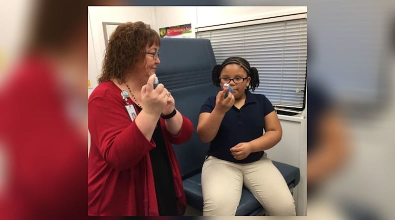 Lisa Montgomery, DPS school nurse, works with a student through the Mobile Health Unit. CONTRIBUTED