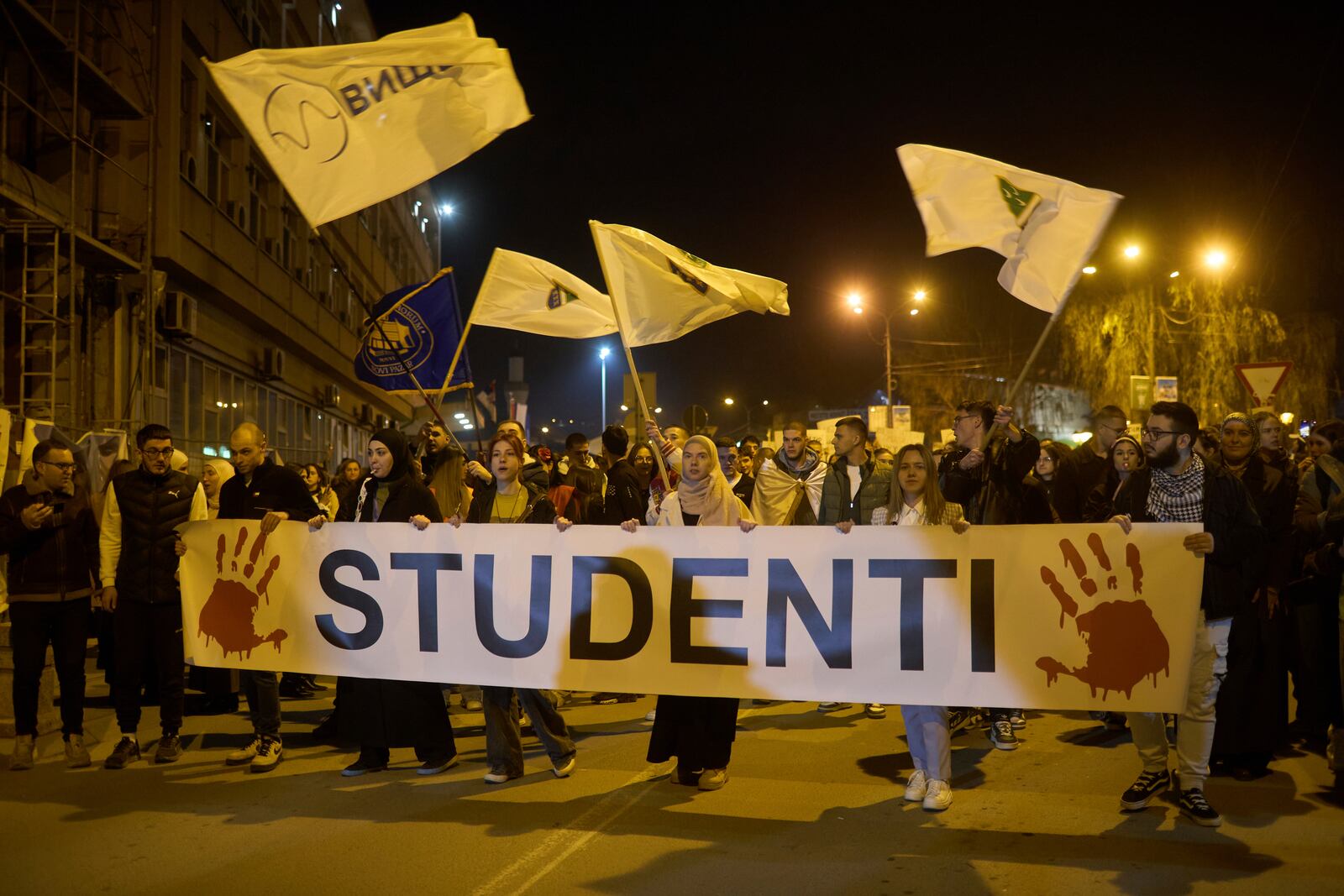 Students carry a banner reading "Students" in Serbian Latin alphabet during an anti-corruption protest in the southwestern town of Novi Pazar, Serbia, Friday, April 11, 2025. (AP Photo/Marko Drobnjakovic)
