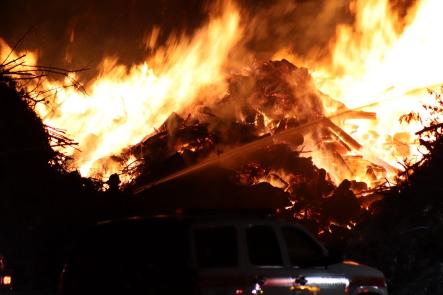 Fire crews battling huge fire in wood piles on Harshman Road