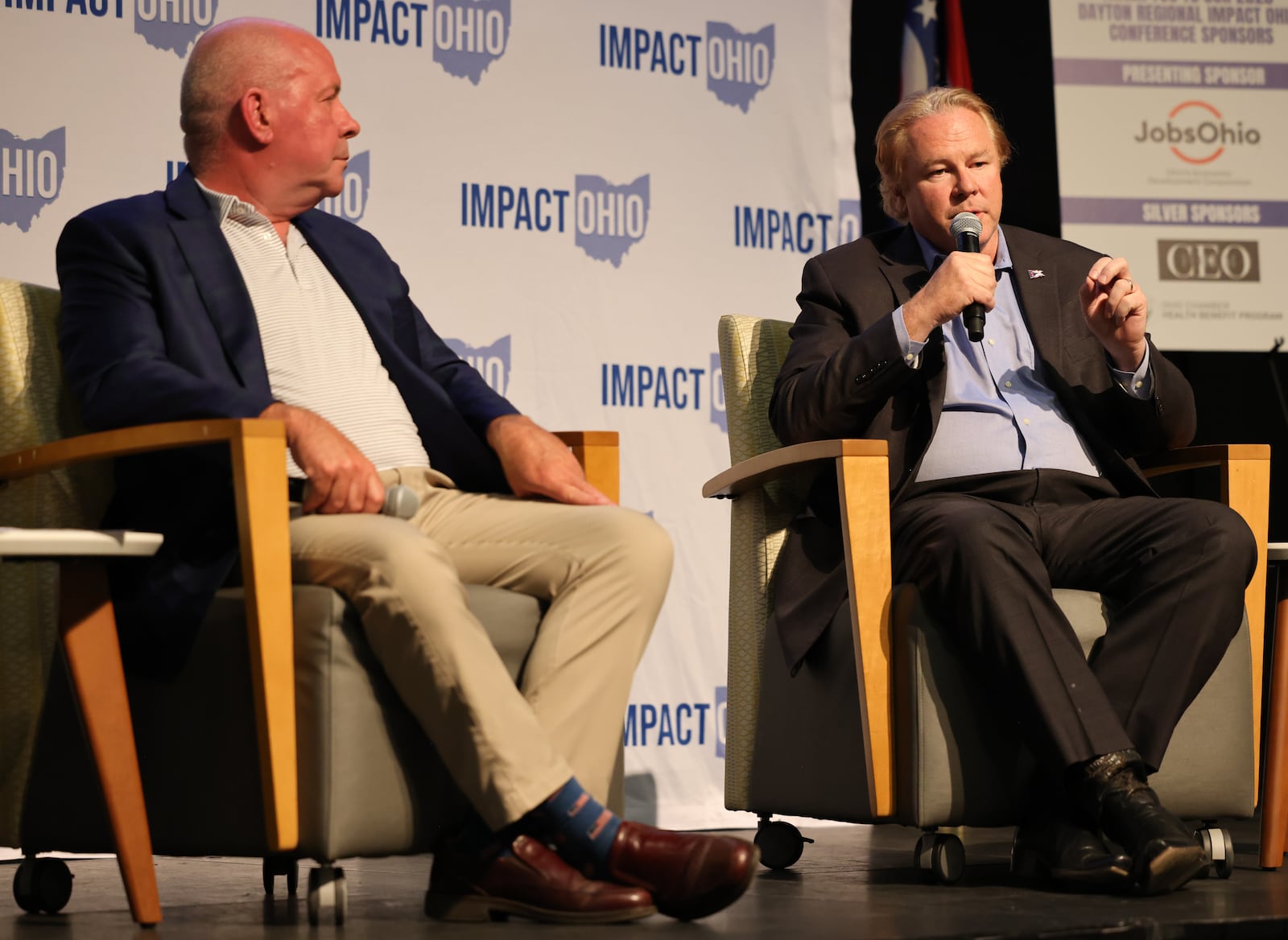 U.S. Rep. Warren Davidson (R-Troy) speaks as Rep. Dave Taylor (R-Amelia) listens during the Ohio Chamber's 2025 Dayton Regional Impact Ohio Conference on Tuesday, Aug. 26, in the Apollo Room in the Student Union at Wright State University. BRYANT BILLING / STAFF
