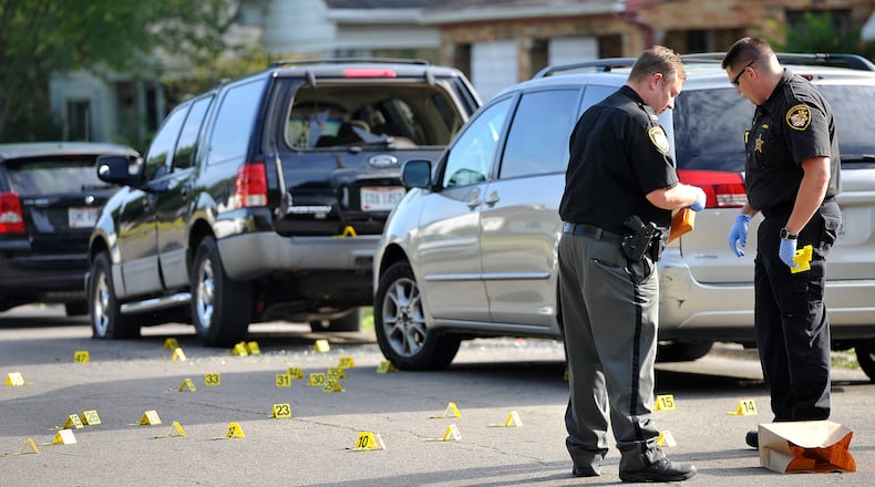 Members of the Montgomery County Sheriff's Office investigate a shooting on Fer Don Road in Harrison Township. MARSHALL GORBY\STAFF