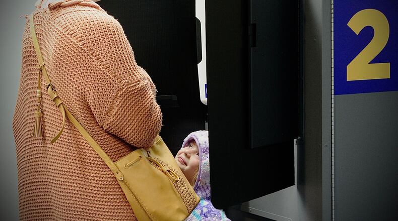 Clara Kerr, 5, smiles at her mom Holly as she votes Tuesday, Nov. 2. Marshall Gorby/Staff Photo