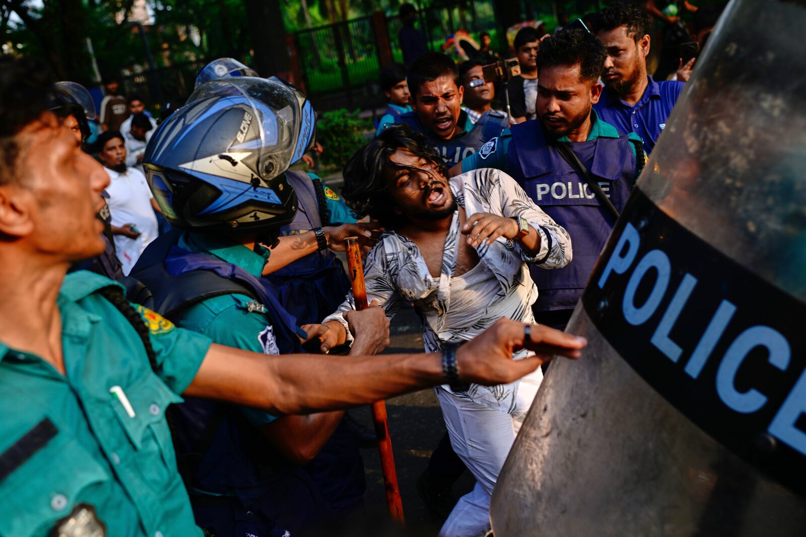 Policemen detain a student protesting near secretariat against the crash of a Bangladesh air force training jet into a school, demanding accountability, compensation for victims' families and the halt of training flights, in Dhaka, Bangladesh, Tuesday, July 22, 2025. (AP Photo/Mahmud Hossain Opu)