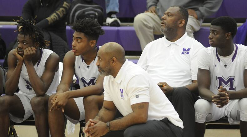 New Beavercreek boys basketball head coach Steve Pittman (second from right) was an assistant to Darnell Hoskins at Middletown last season. MARC PENDLETON / STAFF