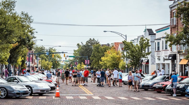 Porsches and people line High St. in Oxford during the 2019 Red Brick Reunion. Photo courtesy of Oxford Visitors Bureau