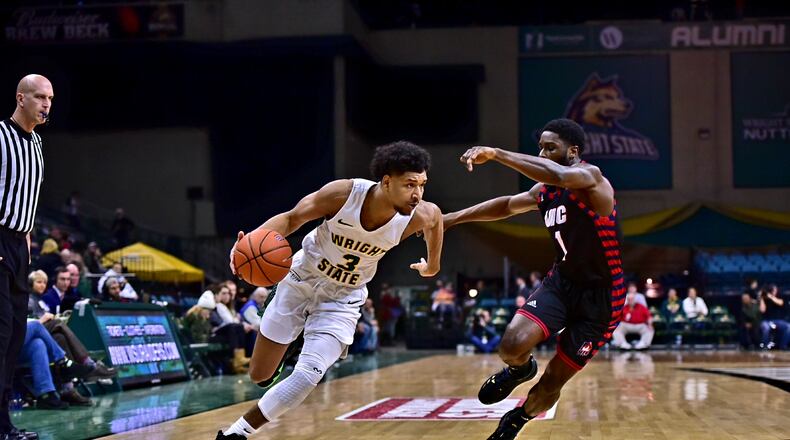 Wright State’s Mark Hughes tries to drive around UIC’s Marcus Ottey during Friday’s game at the Nutter Center. Josepth Craven/CONTRIBUTED