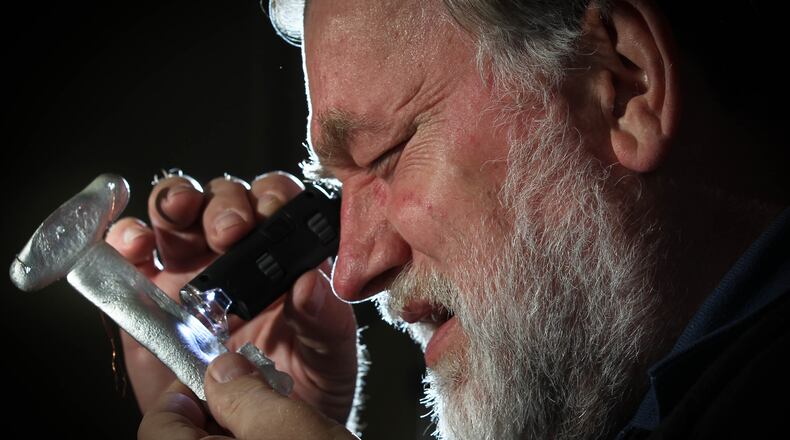 Third Millennium Metals CEO Louis Luedtke inspects a casting. The Dayton company will begin production later this year of a metals composition products it's calling covetics.