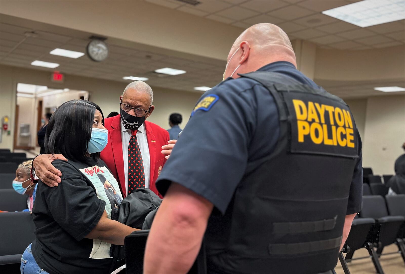 Melissa Chancellor, the mother of homicide victim Damian Chancellor, speaks to Dayton Mayor Jeffrey Mims Jr. and police officials after a city commission meeting in January 2023. CORNELIUS FROLIK /STAFF
