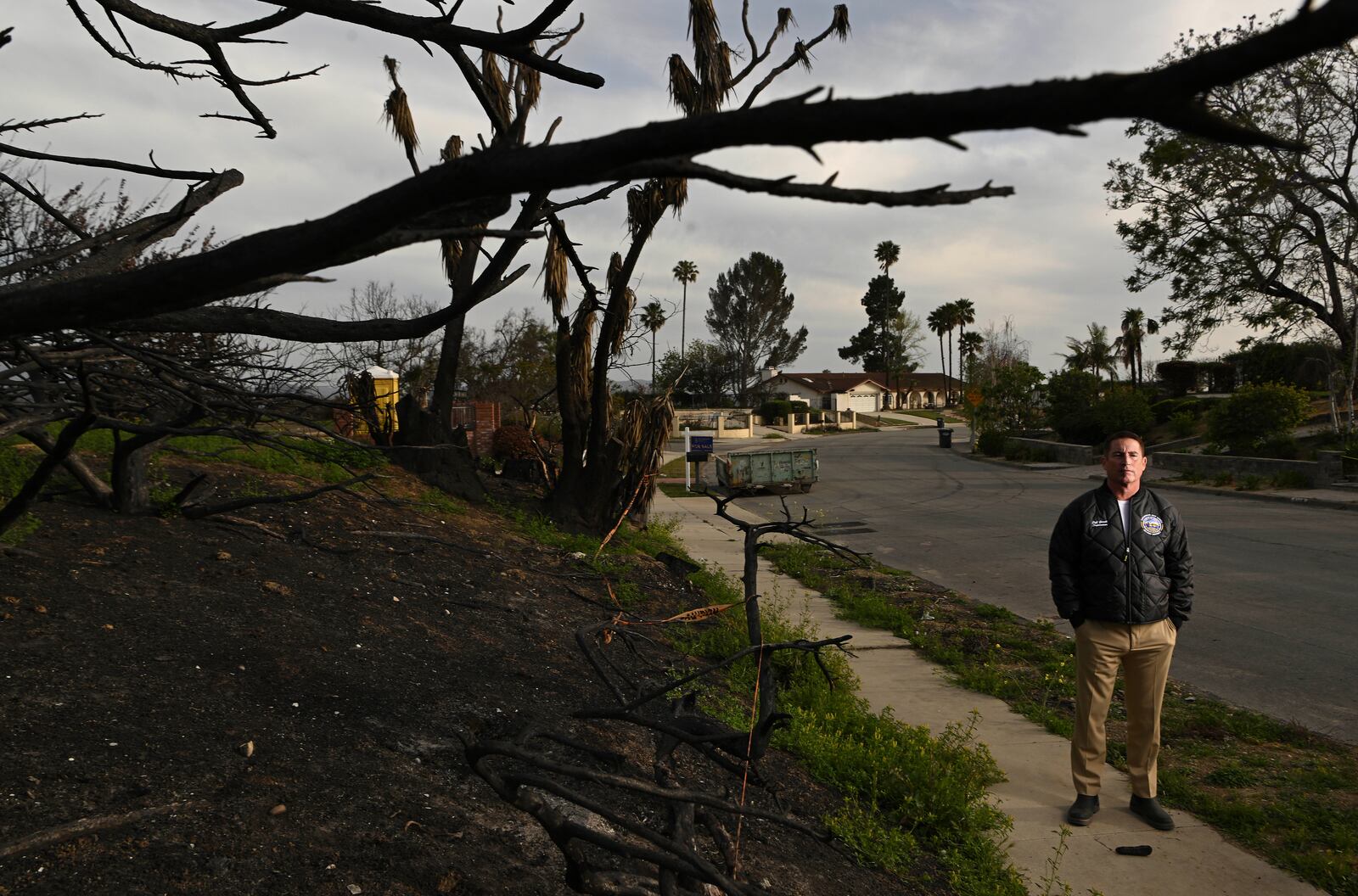 Supervisor Jeff Gorrell stands next to damage from the Mountain Fire along Old Coach Drive Wednesday, April 16, 2025, in Camarillo, Calif. (AP Photo/Wally Skalij)