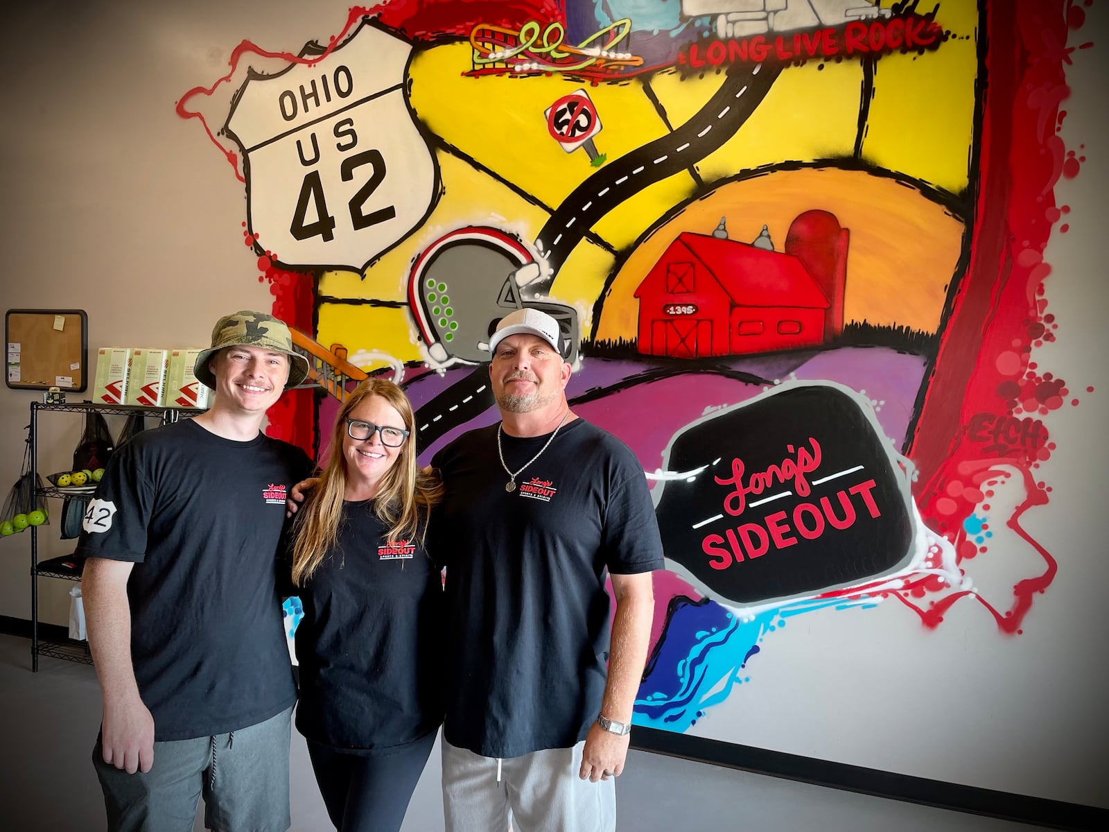 Long’s Sideout Sports & Spirits, a new recreation facility featuring six pickleball courts and a bar, is located at 1395 U.S. 42 S. in Xenia. Pictured (right to left) is Casey and Brittini Long with their son, Christian Lasson. NATALIE JONES/STAFF