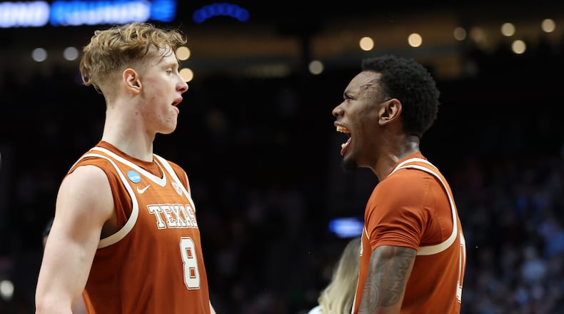 Texas center Matas Vokietaitis (8) celebrates with forward Nic Codie after the second round of the NCAA college basketball tournament against the Gonzaga, Saturday, March 21, 2026, in Portland, Ore.(AP Photo/Amanda Loman)