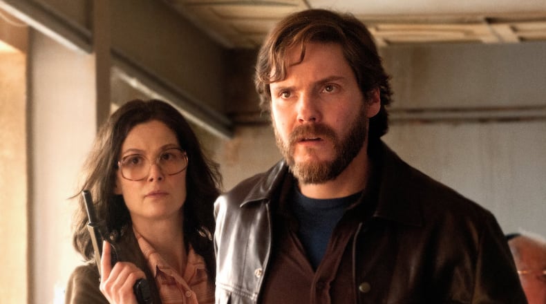 Rosamund Pike (left) stars as “Brigitte Kuhlman” and Daniel Brühl (right) stars as “Wilfred Bose” in José Padilha’s “7 Days in Entebbe.” Contributed by Liam Daniel / Focus Features