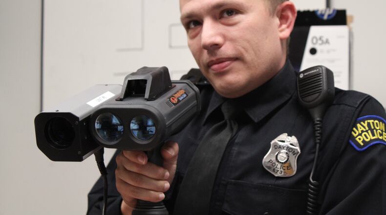 Dayton police Detective Jason Ward, of the department’s crash reconstruction unit, holds a Lidar speed gun. CORNELIUS FROLIK / STAFF