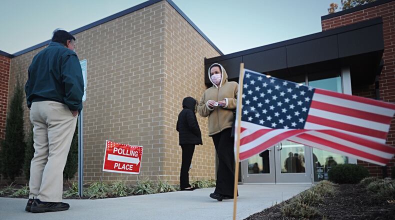 Voters lineup on Election Day outside the Southeast branch of the Dayton Metro Library at 21 Watervliet Ave. MARSHALL GORBY\STAFF