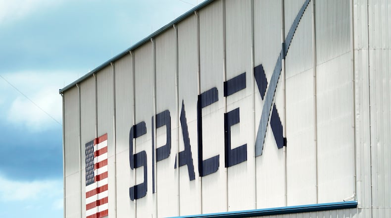 FILE - A SpaceX logo is displayed on a building, May 26, 2020, at the Kennedy Space Center in Cape Canaveral, Fla. (AP Photo/David J. Phillip, File)