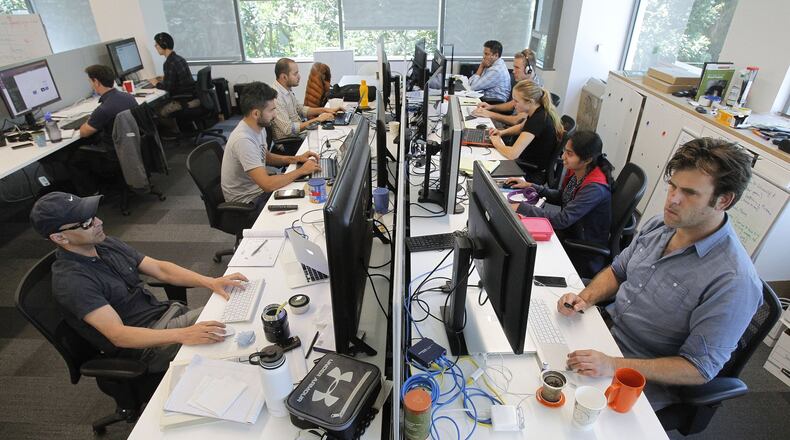 Vice President of Software Development Sam Dribin, front right, company cofounder Homa Karimabadi, front left, and other staff with CureMetrix, a company that analyzes mammograms, work at EvoNexus, a technology and life sciences incubator, in San Diego, Calif. on Thursday, Aug. 3, 2017. More than 190 companies have been admitted to the EvoNexus incubator since 2009. It has location in University City and Irvine. (Hayne Palmour IV/San Diego Union-Tribune/TNS)