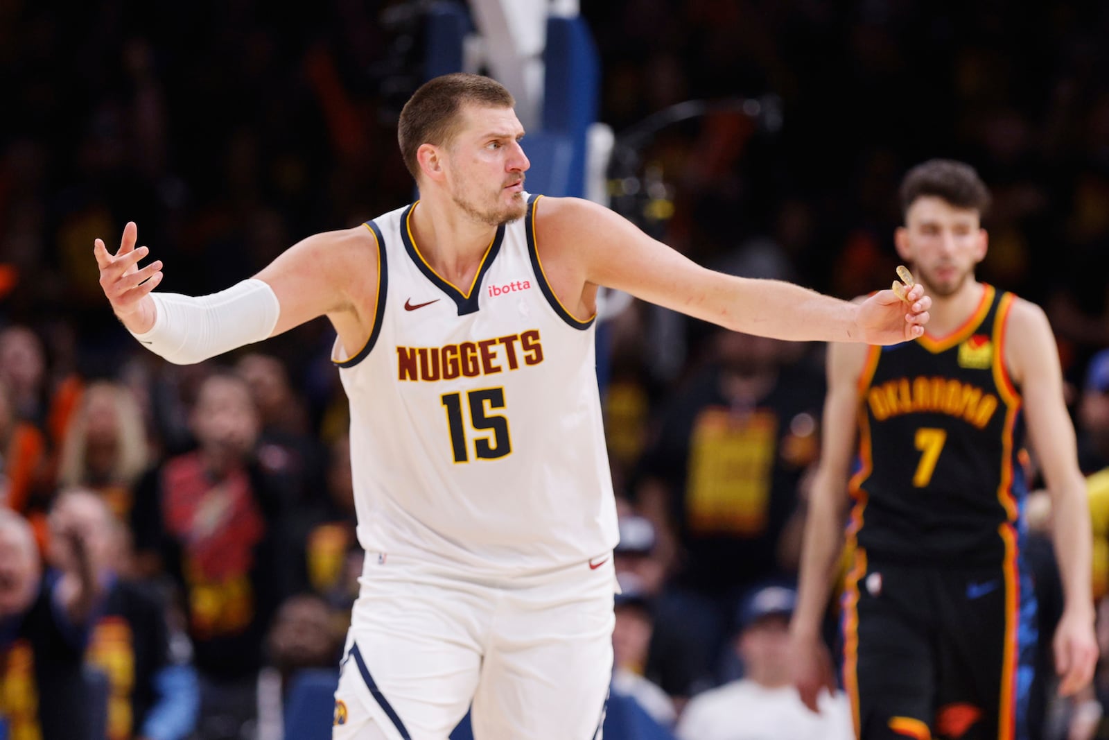 Denver Nuggets' Nikola Jokic (15) reacts to an officials call as Oklahoma City Thunder's Chet Holmgren (7) looks on in the second half of Game 1 of an NBA basketball second-round playoff series Monday, May 5, 2025, in Oklahoma City. (AP Photo/Nate Billings)