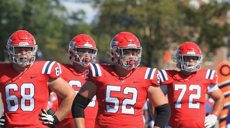 Dayton's offensive linemen wait for a play call during a game against Presbyterian on Saturday, Sept. 25, 2021, at Welcome Stadium. David Jablonski/Staff