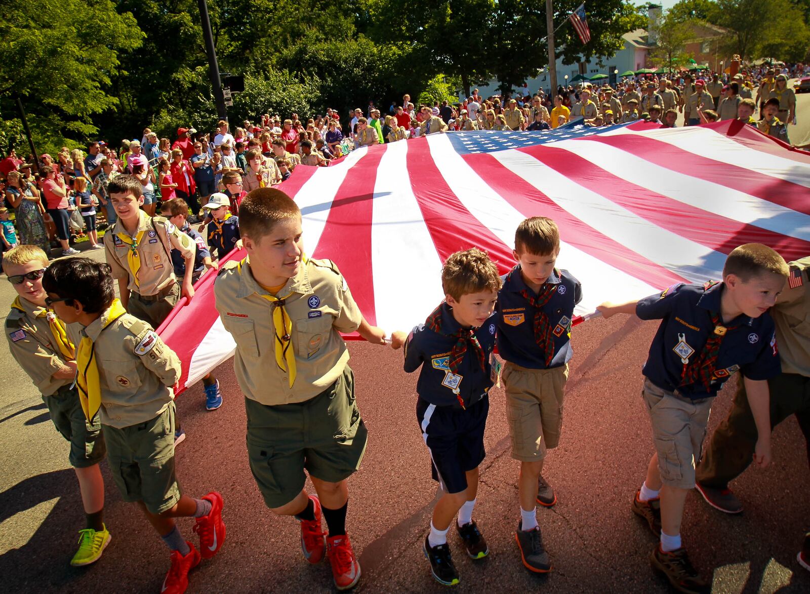 File - Local scouts carry the flag in the Americana parade held on July 4, 2014, one of the area's largest annual Independence Day festival events. JIM WITMER / STAFF