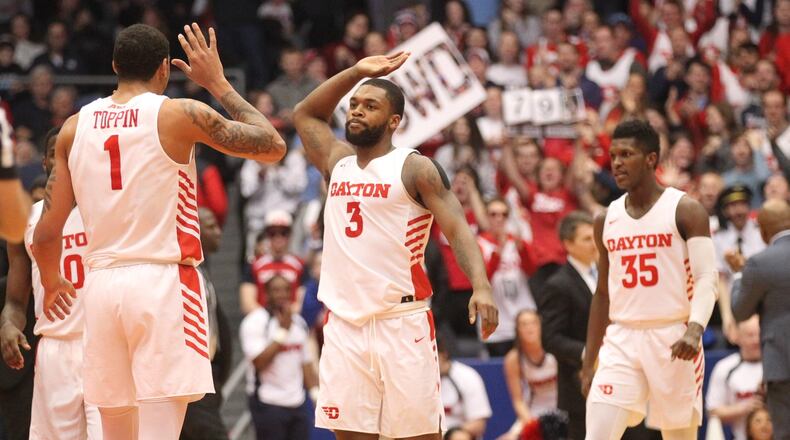 Dayton’s Trey Landers slaps hands with Obi Toppin after a dunk by Toppin against La Salle on Wednesday, March 6, 2019, at UD Arena. David Jablonski/Staff
