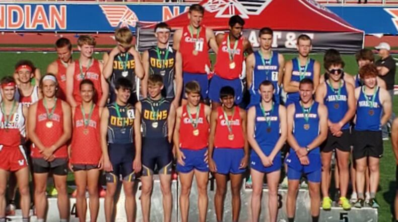 Carroll stands in the center of the podium after winning the 4x800 relay on the first day of the Division II region track meet at Piqua High School. Greeneview (right) placed third. Both advance to state. Greeneview High School/CONTRIBUTED