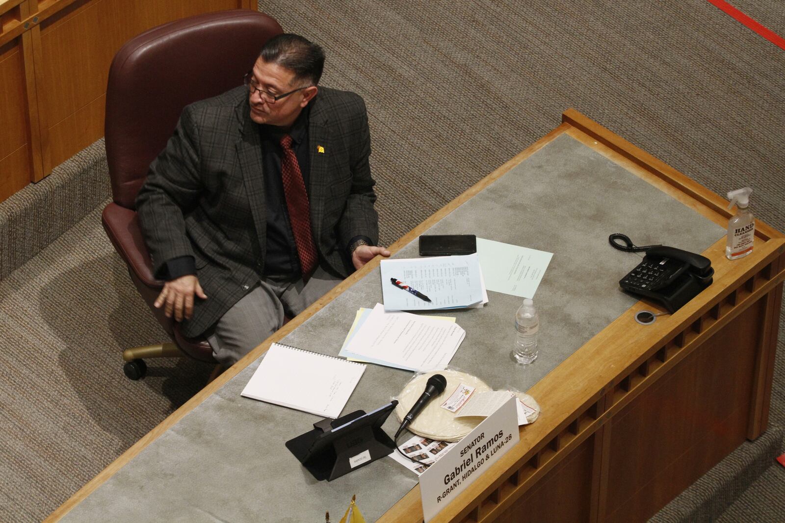 Republican state Sen. Gabriel Ramos of Silver City, N.M., rests the microphone on a stack of locally made tortillas amid debate on a bill to designate tortillas as the official state bread in Santa Fe, N.M., on Tuesday, March 18, 2025. (AP Photo/Morgan Lee)