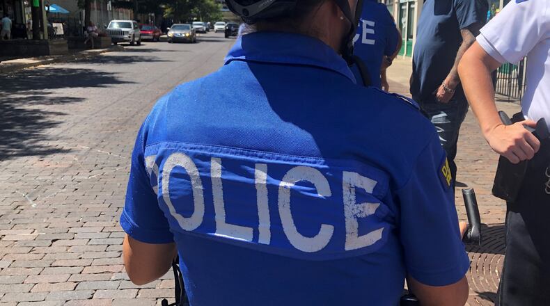 A Dayton police officer in the Oregon District. CORNELIUS FROLIK / STAFF