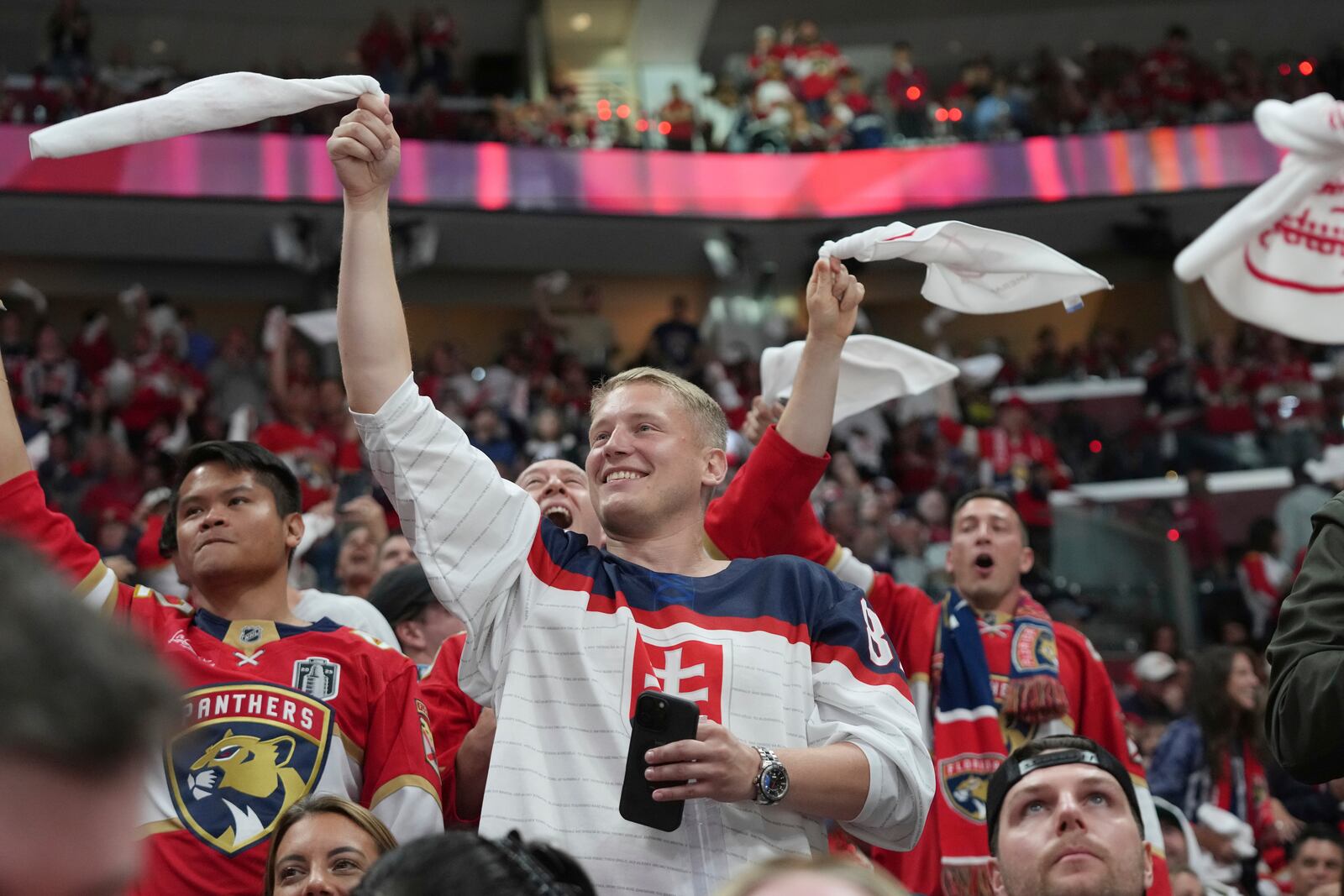 Florida Panthers fans celebrate a goal by center Sam Reinhart during the second period of Game 6 of the NHL hockey Stanley Cup Final against the Edmonton Oilers Tuesday, June 17, 2025, in Sunrise, Fla. (AP Photo/Lynne Sladky)