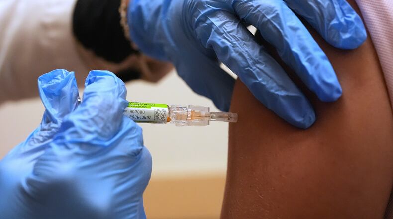 FILE - Pharmacy manager Aylen Amestoy administers a patient with a seasonal flu vaccine at a CVS Pharmacy in Miami, Tuesday, Sept. 9, 2025. (AP Photo/Rebecca Blackwell, File)