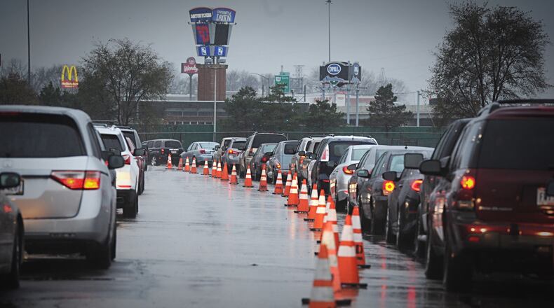 People braved a cold and chilly morning to line up for free Thanksgiving meals in November 2020. MARSHALL GORBY/STAFF