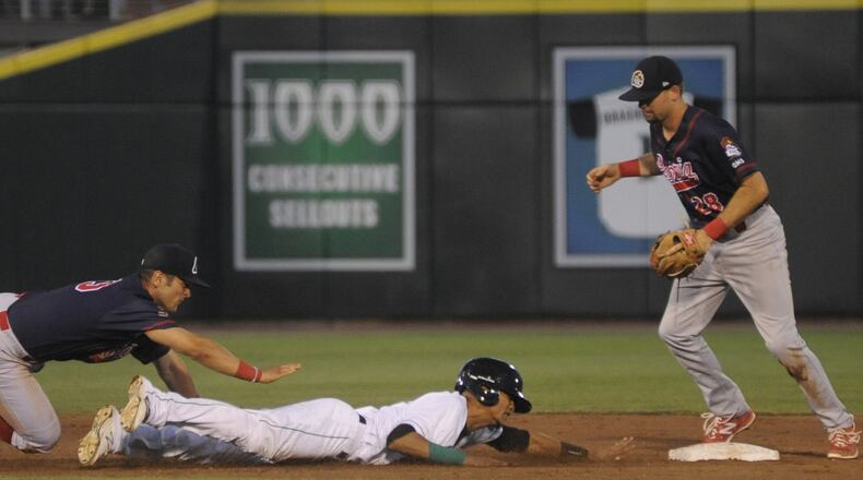 Jose Siri of the Dragons slides safely back to second base after getting caught in a rundown. The Dragons hosted the Peoria Chiefs (Cardinals) at Dayton’s Fifth Third Field in a Class A minor-league baseball game on Wednesday, July 19, 2017. MARC PENDLETON / STAFF