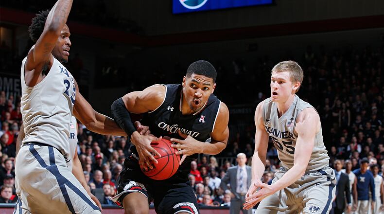 CINCINNATI, OH - JANUARY 26: Kyle Washington #24 of the Cincinnati Bearcats goes to the basket against J.P. Macura #55 and RaShid Gaston #35 of the Xavier Musketeers in the second half of the game at Fifth Third Arena on January 26, 2017 in Cincinnati, Ohio. Cincinnati defeated Xavier 86-78. (Photo by Joe Robbins/Getty Images)