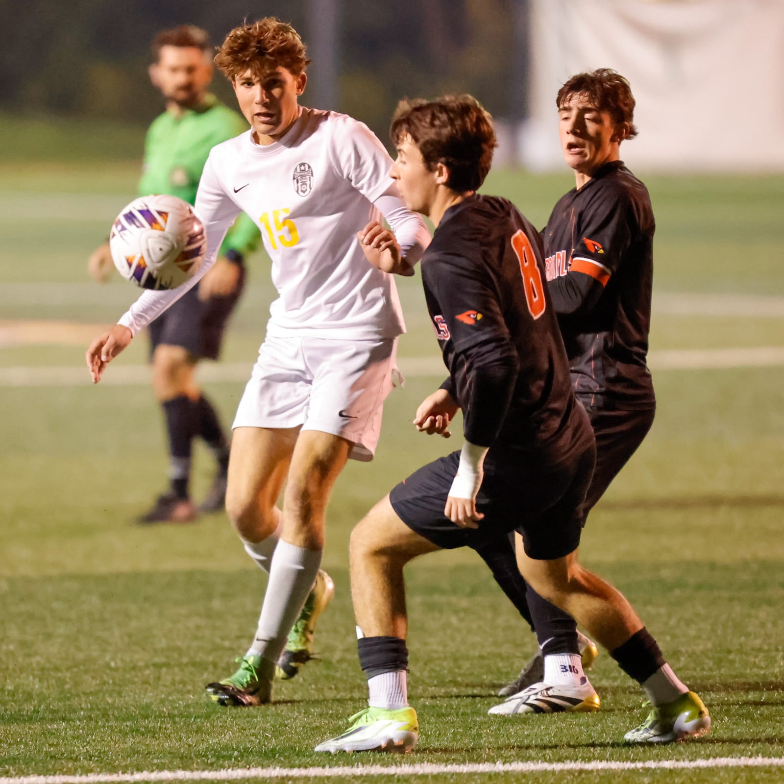 Centerville High School senior Gavin Cutler passes the ball ahead of St. Charles senior Owen Sugar (8) during their Division I regional final match against Columbus St. Charles on Sunday, Nov. 2 at Wright State University's Alumni Field. The Cardinals won 2-0. MICHAEL COOPER / STAFF PHOTO