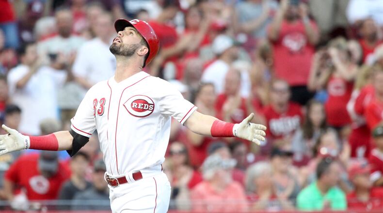 The Reds Jesse Winker crosses home plate after a home run against the Brewers on Thursday, June 28, 2018, at Great American Ball Park in Cincinnati. David Jablonski/Staff