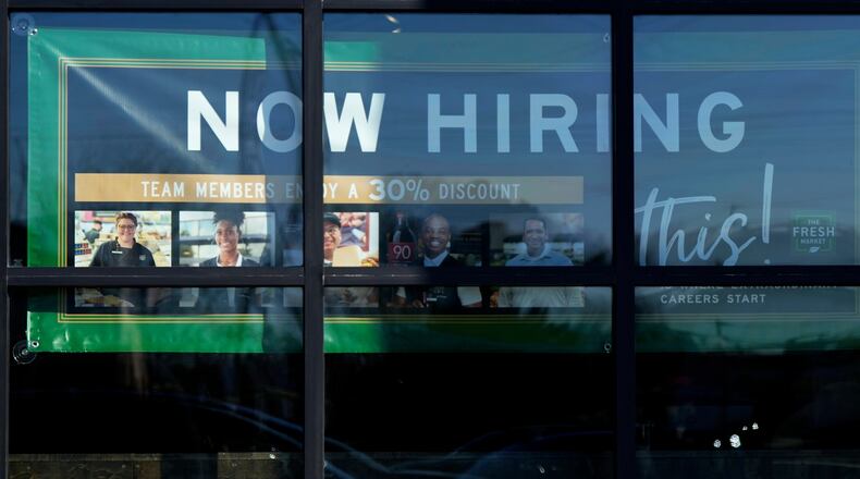 FILE - A hiring sign is displayed at a grocery store in Northbrook, Ill., Tuesday, Jan. 21, 2025. (AP Photo/Nam Y. Huh)